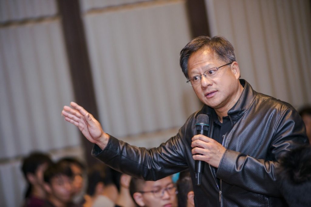Nvidia CEO Jensen Huang speaking into a microphone at Computex in Taipei