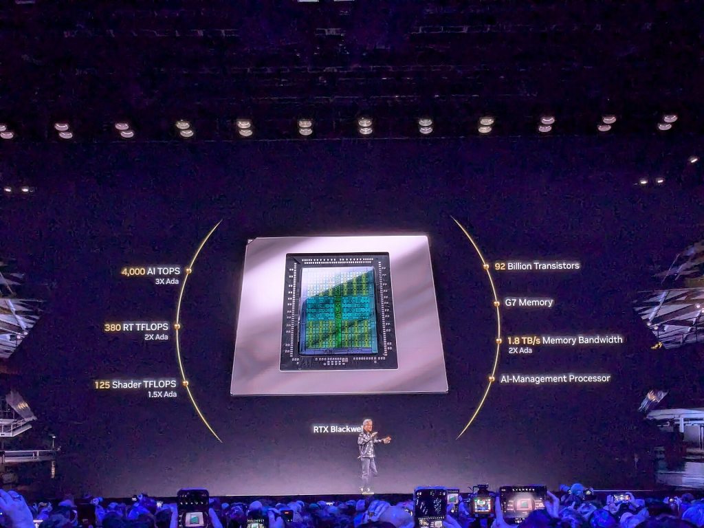 Jensen Huang on stage at CES 2025 in front of a giant RTX Blackwell chip listing 92 billion transistors and GDDR7 memory