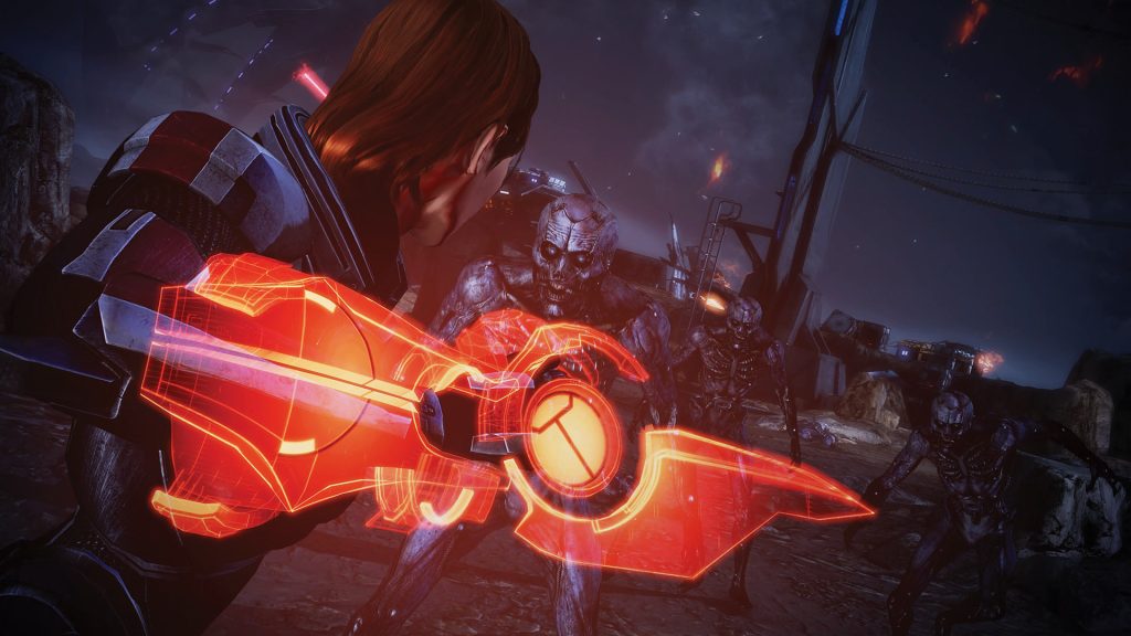 Commander Shepard with an omni-blade fighting husks in Mass Effect Legendary Edition