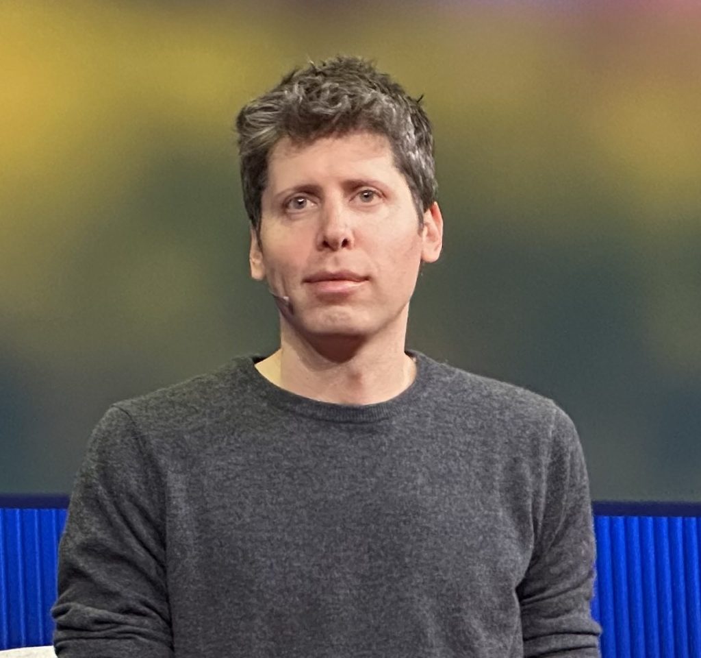 OpenAI CEO Sam Altman speaking on stage at TED