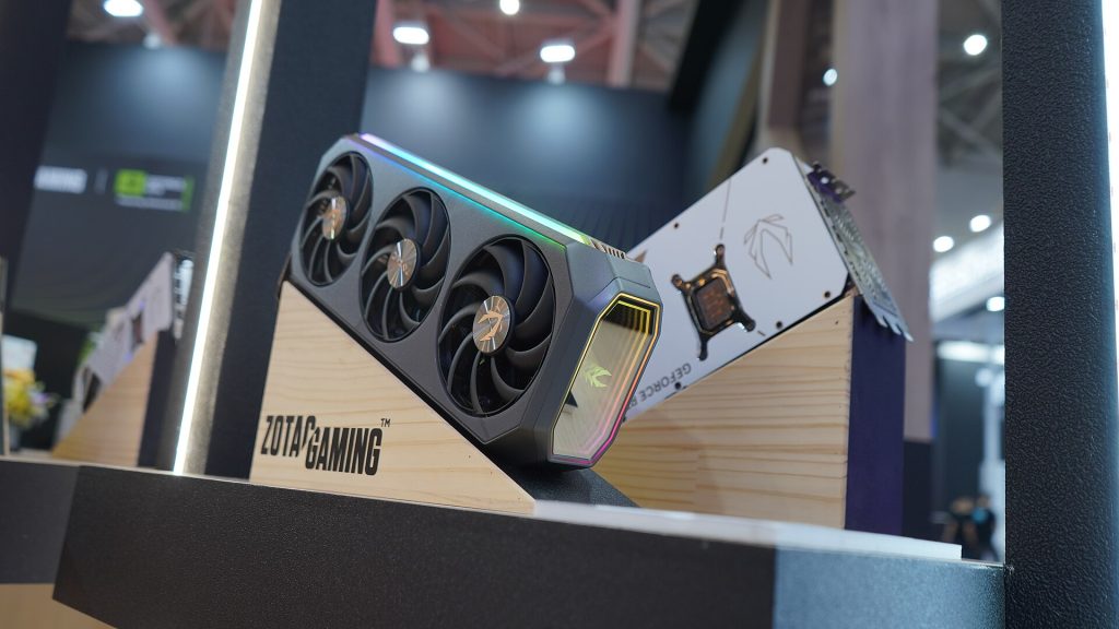 Two Zotac Gaming GeForce RTX 50 series graphics cards on display stands at a trade show